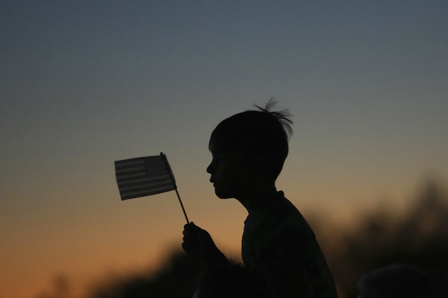 Damian Pecci, 8, of Scottsdale, Ariz., attends a Catholic rosary prayer vigil with his family and others for Charlie Kirk after he was shot and killed during a Utah college event Wednesday, Sept. 10,  ...