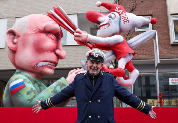 epaselect epa12745673 German artist Jacques Tilly, who designed the floats of the Rose Monday carnival parade (Rosenmontag), poses in front of one of his carnival floats depicting Russian President Vl ...