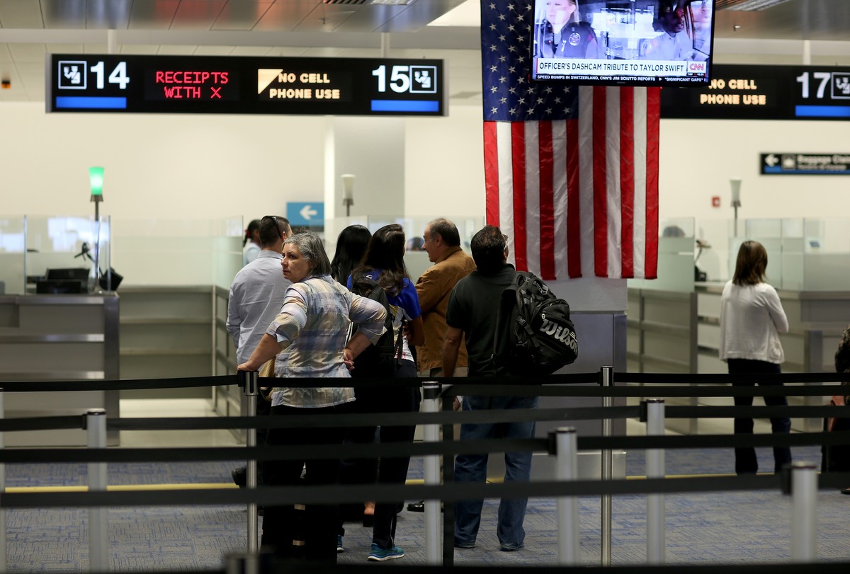 MIAMI, FL - MARCH 04: International travelers wait in line to speak with a CBP officer as they arrive at Miami International Airport on March 4, 2015 in Miami, Florida. Miami-Dade Aviation Department  ...