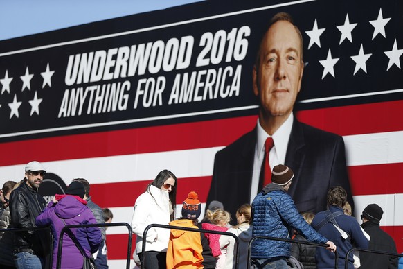 FILE- In this Saturday, Feb. 13, 2016 file photo, people stand in line waiting to enter the Underwood 2016 booth near the Peace Center where the CBS News Republican presidential debate will occur, in ...