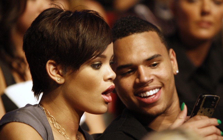 Rihanna, left, and Chris Brown are seen at the MTV Movie Awards on Sunday June 1, 2008 in Los Angeles. (AP Photo/Matt Sayles)