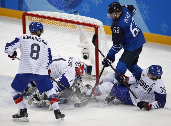 Goalie Matt Dalton (1), of South Korea, blocks a shot by Oskar Osala (62), of Finland, during the first period of the qualification round of the men's hockey game at the 2018 Winter Olympics in Gangneung, South Korea, Tuesday, Feb. 20, 2018. (AP Photo/Jae C. Hong)