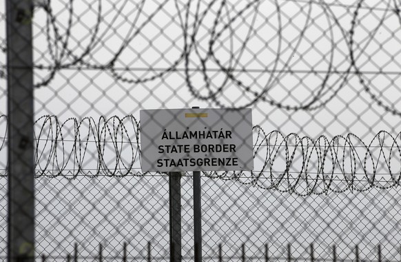 FILE - In this file photo dated Monday, April 8, 2019, a sign reading: &quot;State Border&quot; is attached to a fence at Hungary&#039;s border with Serbia near the village Asotthalom, Hungary. The Eu ...