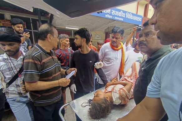 An injured from temple stampede is carried inside a hospital in Haridwar, India, Sunday, July 27, 2025. (AP Photo)
India Temple Crowd