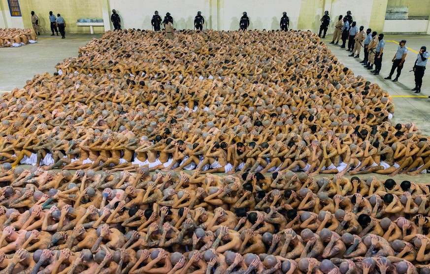 epa10488944 A handout photo made available by the government of El Salvador shows prisoners sitting in the Terrorism Confinement Center (CECOT) in Tecoluca, El Salvador, 24 February 2023. The Governme ...