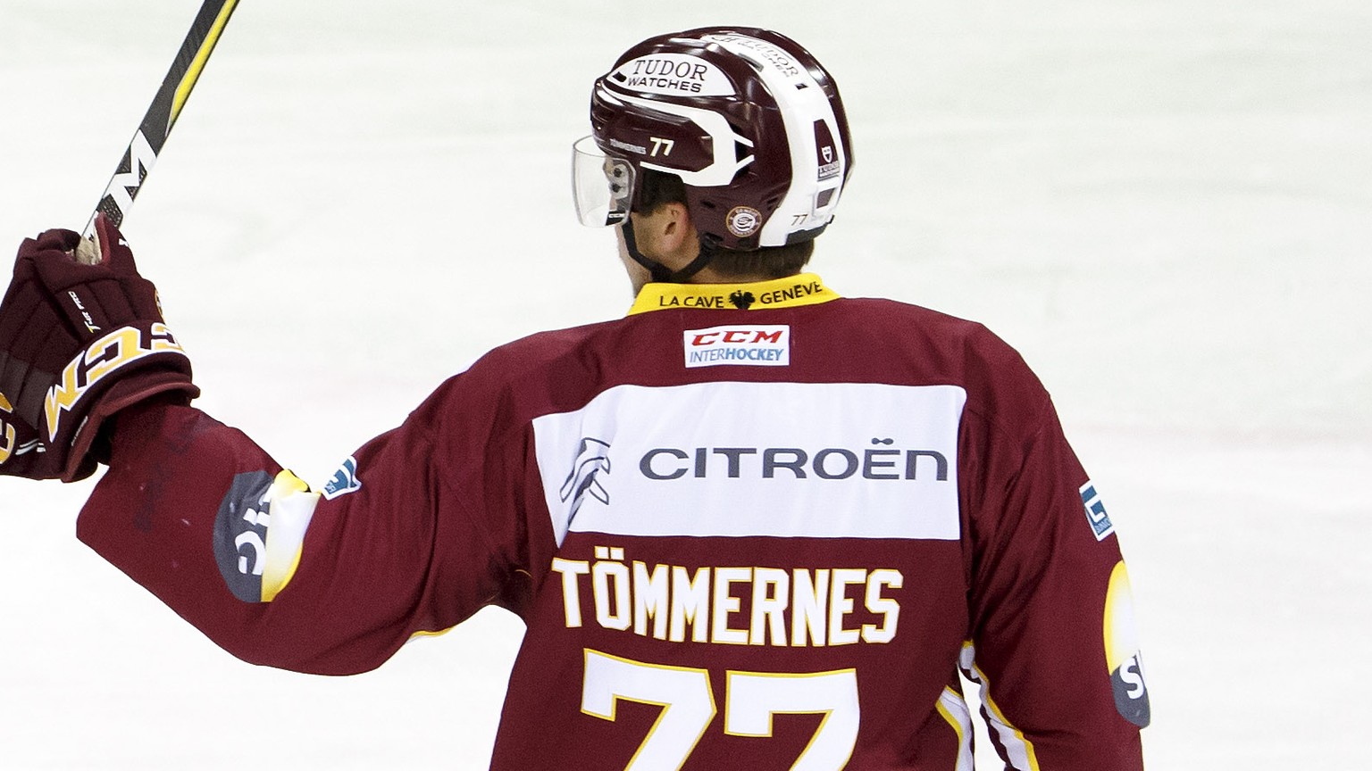 Geneve-Servette&#039;s forward Damien Riat, left, celebrates his goal with teammates defender Henrik Toemmernes, of Sweden, right, after scored the 1:0, during a National League regular season game of ...