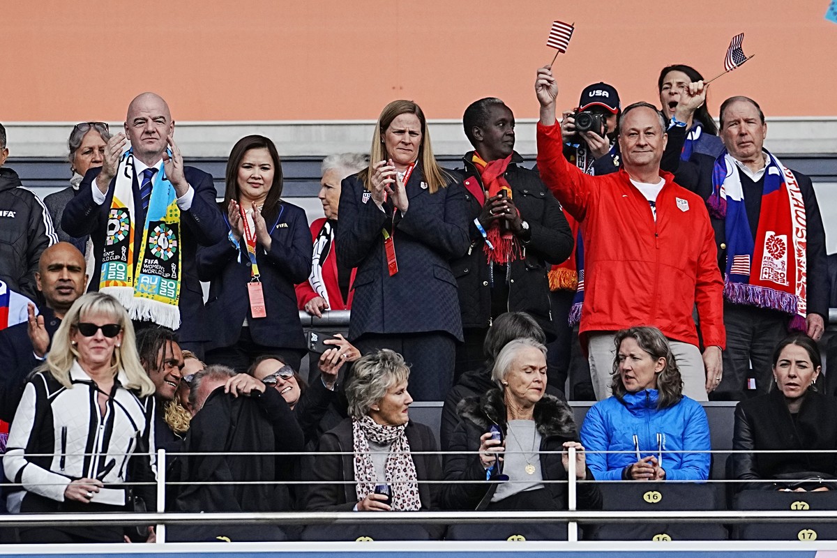 Second gentleman Doug Emhoff, second from right, waves a flag before the Women's World Cup Group E soccer match between the United States and Vietnam at Eden Park in Auckland, New Zealand, Saturd ...
