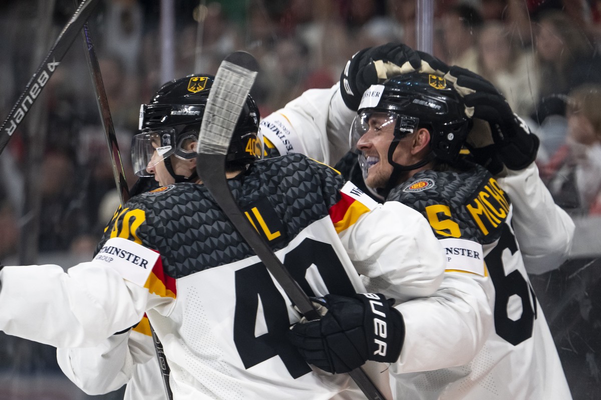 Germany's Marc Michaelis, right, celebrates his 2-3 goal with teammates during the 2026 IIHF Men's Ice Hockey World Championship preliminary round group A game between United States and Germ ...