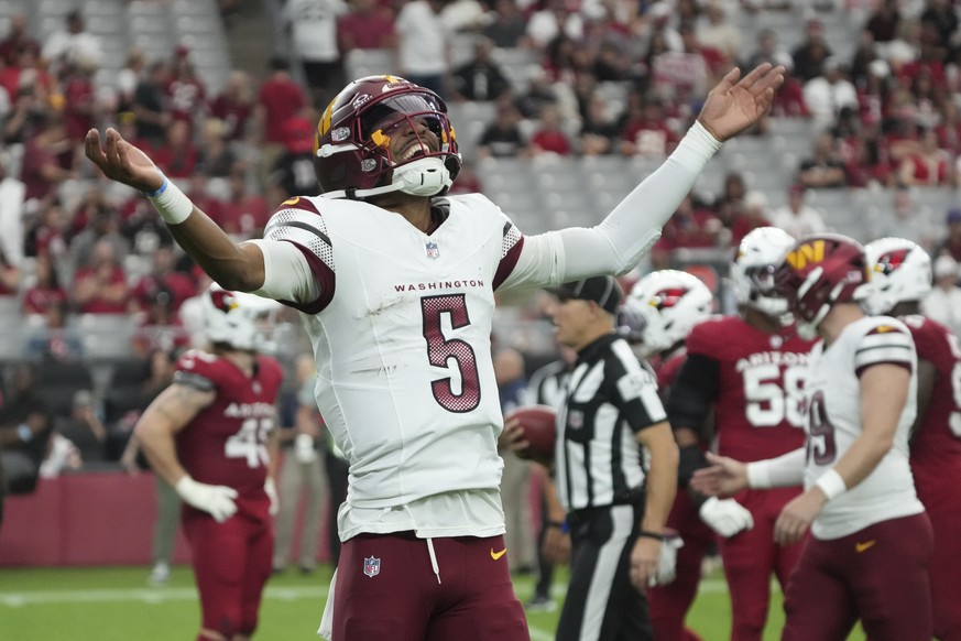 Washington Commanders quarterback Jayden Daniels (5) celebrates a touchdown against the Arizona Cardinals during the second half of an NFL football game, Sunday, Sept. 29, 2024, in Glendale, Ariz. (AP ...
