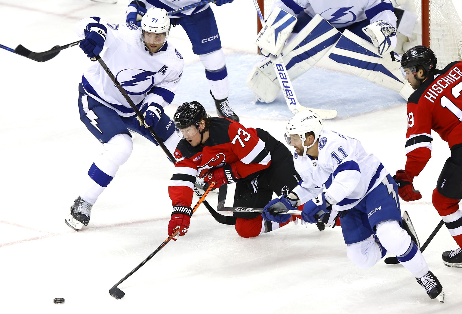 New Jersey Devils right wing Tyler Toffoli (73) vies for the puck against Tampa Bay Lightning defenseman Victor Hedman (77) and center Luke Glendening (11) during the third period of an NHL hockey gam ...