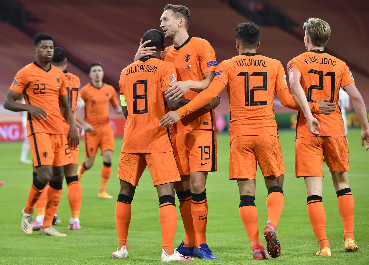 Netherlands' Luuk de Jong, center right, hugs Netherlands' Georginio Wijnaldum who scored his side's first goal during the UEFA Nations League soccer match between The Netherlands and B ...