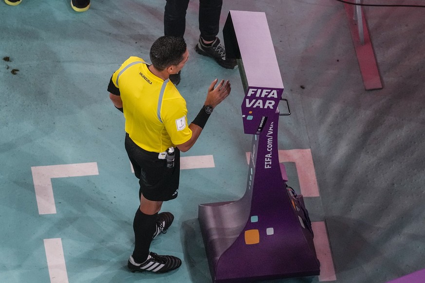 Referee Jesus Valenzuela from Venezuela checks the VAR screen during the World Cup round of 16 soccer match between France and Poland, at the Al Thumama Stadium in Doha, Qatar, Sunday, Dec. 4, 2022. ( ...