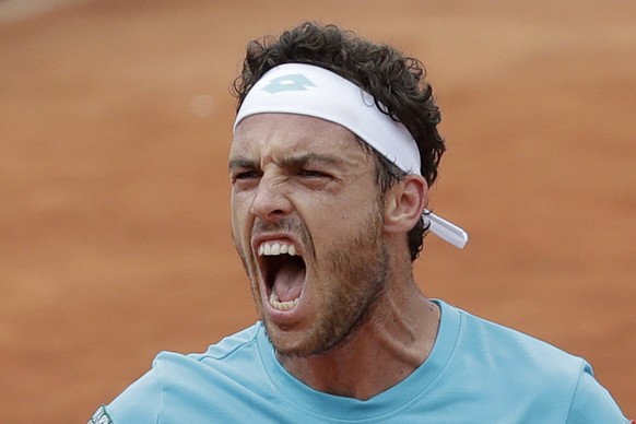 Italy&#039;s Marco Cecchinato celebrates winning the second set against Serbia&#039;s Novak Djokovic during their quarterfinal match of the French Open tennis tournament at the Roland Garros stadium i ...