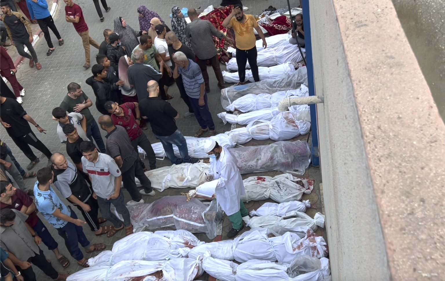 EDS NOTE: GRAPHIC CONTENT - In this frame shot from the video, covered bodies lie outside an Indonesian hospital after Israeli airstrikes on the Jabaliya refugee camp on the outskirts of Gaza City, Tuesday...