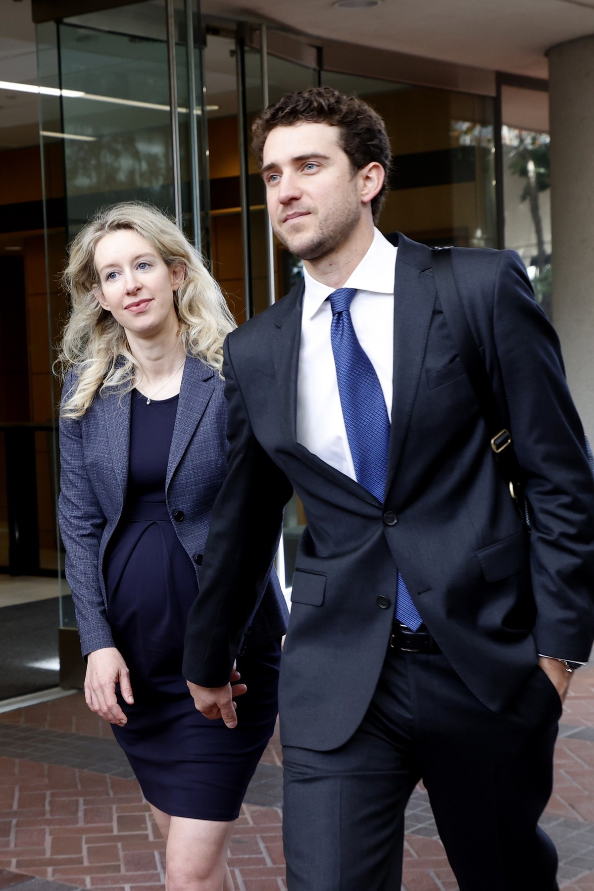 epa10249263 Elizabeth Holmes (L), founder of Theranos, her partner, Billy Evans (R) leave the Robert F. Peckham Federal Building and US Courthouse in San Jose, California, USA, 17 October 2022. Holmes ...