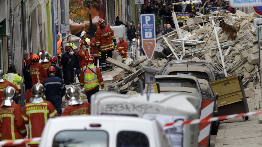 Firefighters work at the scene where a building collapsed In Marseille, southern France, Monday, Nov. 5, 2018. A building collapsed in the southern city of Marseille on Monday, leaving a giant pile of ...