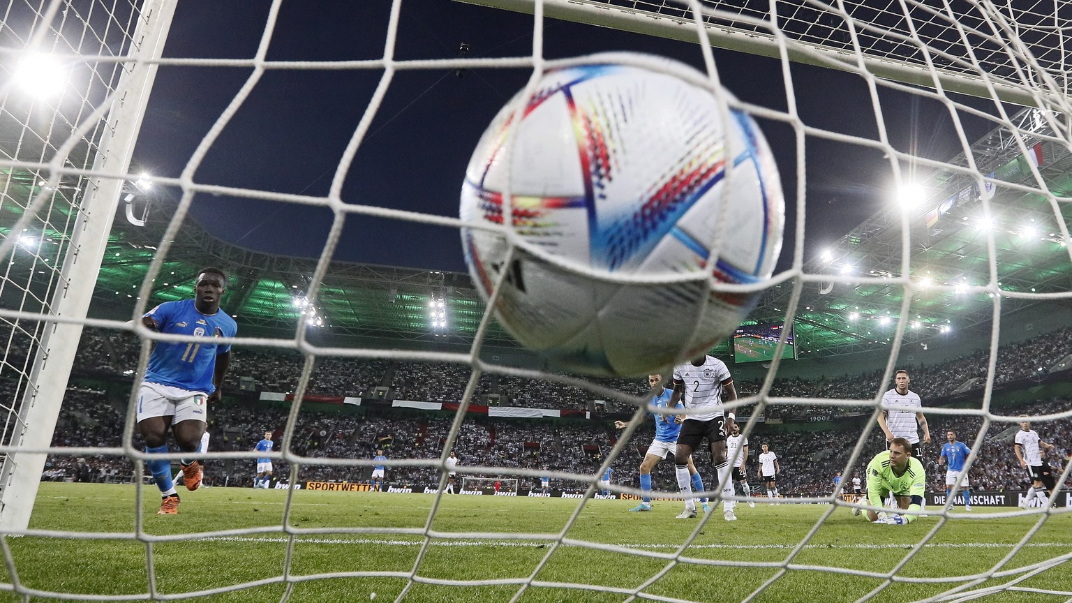 Germany&#039;s keeper Manuel Neuer receives a goal from Italy&#039;s Degnand Gnonto, left, during the UEFA Nations League soccer match between Germany and Italy in Moenchengladbach, Germany, Tuesday,  ...