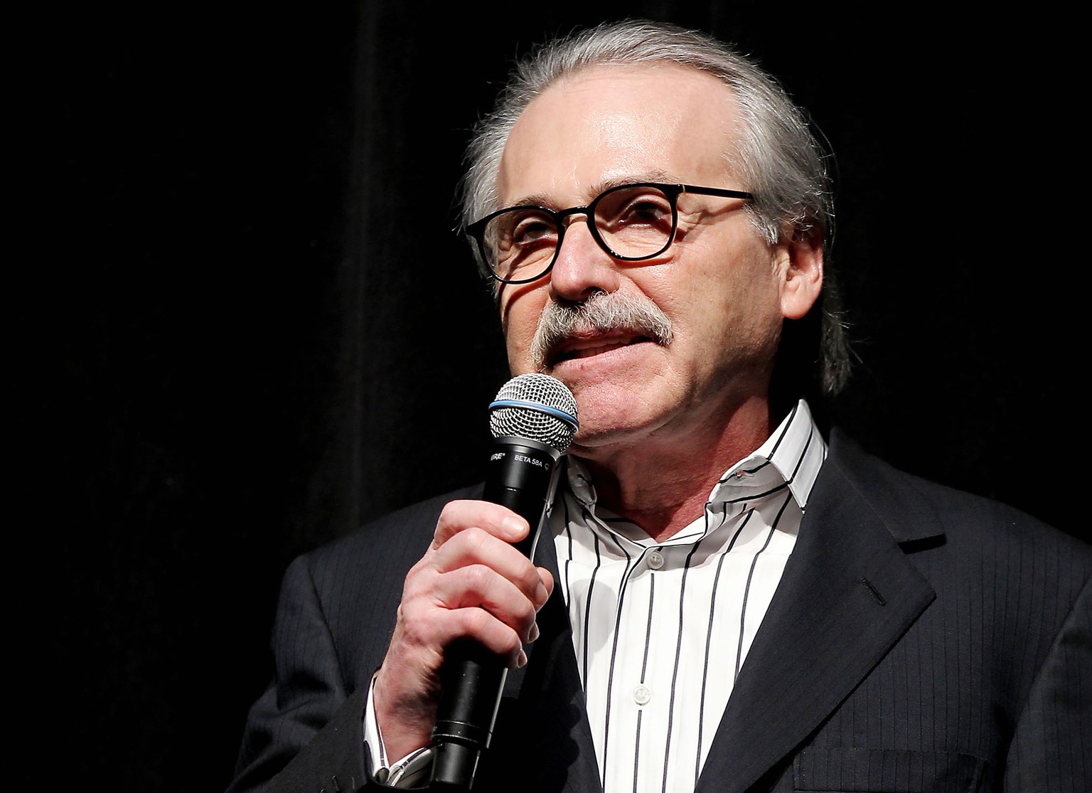 In this Jan. 31, 2014 photo, David Pecker, Chairman and CEO of American Media, addresses those attending the Shape &amp; Men&#039;s Fitness Super Bowl Party in New York. The Aug. 21, 2018 plea deal re ...