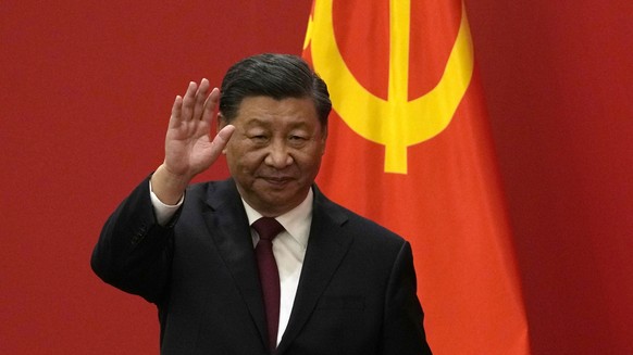 FILE - Chinese President Xi Jinping waves at an event to introduce new members of the Politburo Standing Committee at the Great Hall of the People in Beijing on Oct. 23, 2022. The world faces the pros ...