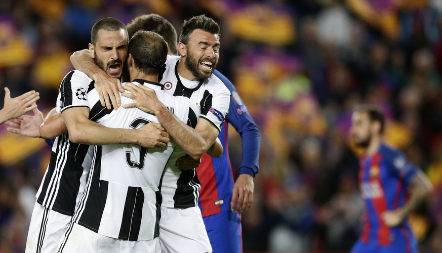 Juventus&#039; Leonardo Bonucci, left, celebrates with teammates Giorgio Chiellini, center, and Andrea Barzagli during the Champions League quarterfinal second leg soccer match between Barcelona and J ...