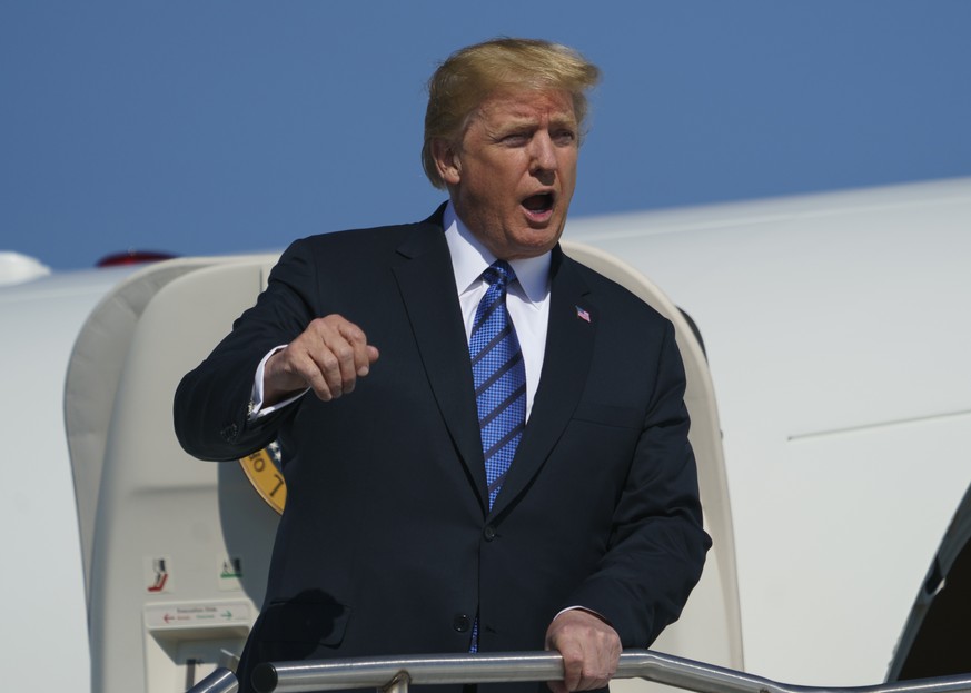 President Donald Trump calls out as he arrives on Air Force One at Morristown Municipal Airport, in Morristown, N.J., Friday, July 20, 2018, en route to Trump National Golf Club in Bedminster, N.J.. ( ...