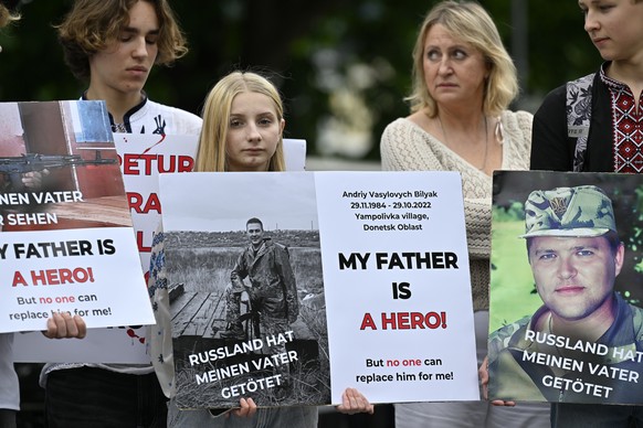 epa11411842 People attend a standing peace rally for the Ukraine Peace Conference organised by the Ukrainian Society in Switzerland and family members of Ukrainian prisoners of war in Lucerne, Switzer ...