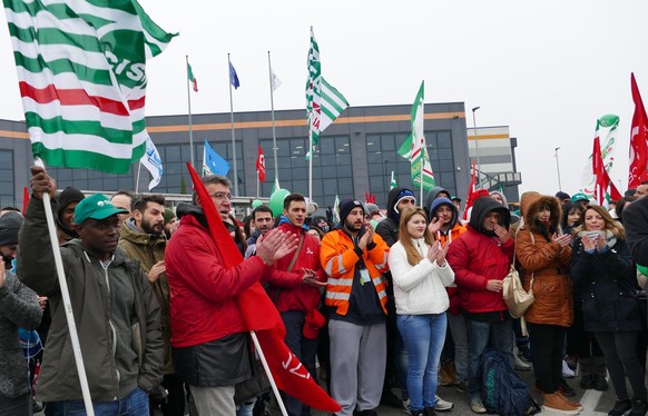 Workers stage a protest in front of an Amazon logistic center in Castel San Giovanni, near Piacenza, northern Italy, Friday, Nov. 24, 2017. Workers at a half dozen Amazon distribution centers in Germa ...