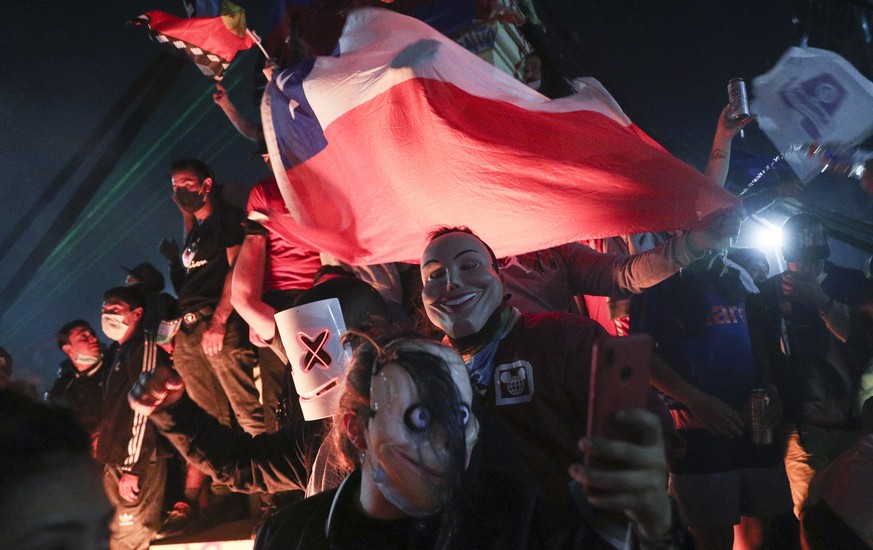 People gather at Plaza Italia on the day Chileans voted in a referendum to decide whether the country should replace its 40-year-old constitution, written during the dictatorship of Gen. Augusto Pinoc ...