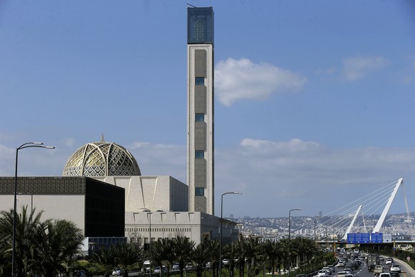 Cars drive past the Djamaa El-Djazair, or Great Mosque of Algiers, Wednesday, February 21, 2024 in Algiers.  The Great Mosque of Algiers, founded in 2012, features a gigantic 265-meter minaret and a hood...