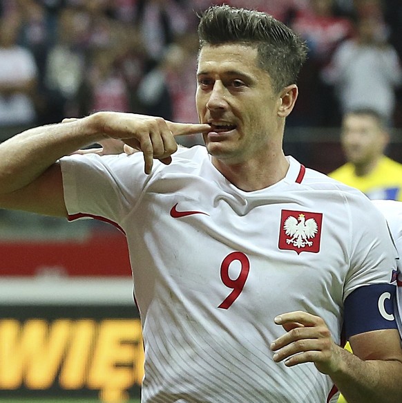 FILE - In this Monday, Sept. 4, 2017 filer, Poland&#039;s Robert Lewandowski,left, celebrates scoring their third goal from the penalty spot with Kamil Grosicki during the World Cup Group E qualifying ...