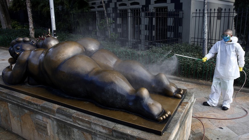 epaselect epa08339907 A man disinfects an sculpture in the Plaza Botero during the national quarantine decreed by the Government to contain the expansion of COVID-19, in Medellin, Colombia, 02 April 2 ...