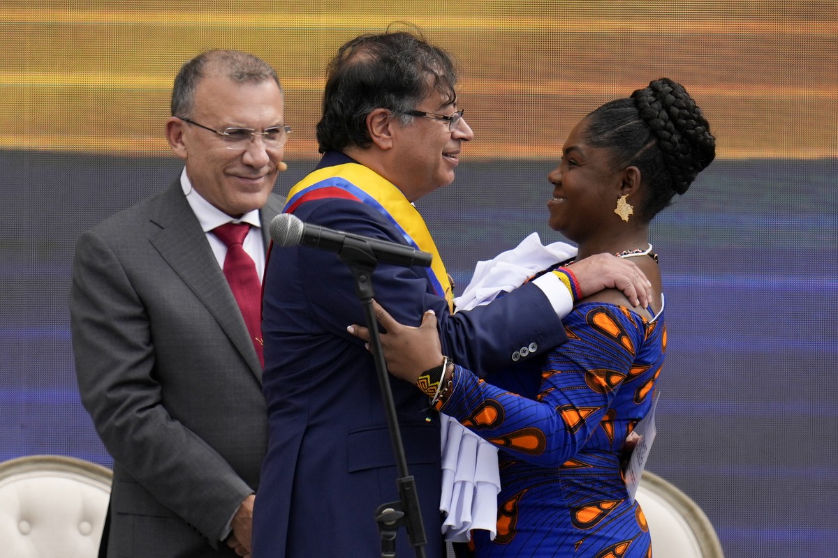 Colombia's President Gustavo Petro, left, embraces Vice-President Francia Marquez after taking her oath of office in Bogota, Colombia, Sunday, Aug. 7, 2022. Back left is Congress President Roy Ba ...