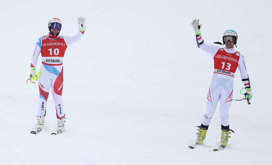 epa06453676 Beat Feuz of Switzerland (L) and Vincent Kriechmayr of Austria (R) react in the finish area during the Men's Super G race of the FIS Alpine Skiing World Cup event in Kitzbuehel, Austria, 1 ...