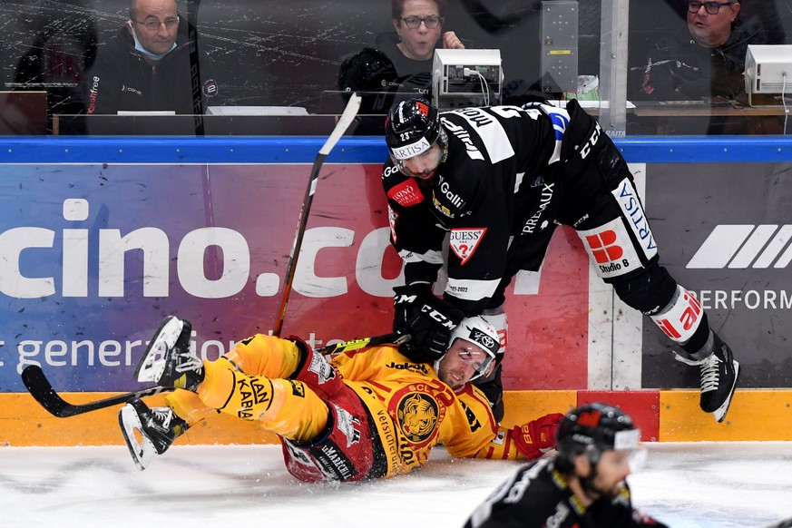 Lugano&#039;s player Giovanni Morini, right, fights for the puck with Tiger&#039;s player Samuel Erni, left, during the preliminary round game of National League A (NLA) Swiss Championship 2020/21 bet ...