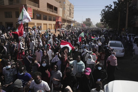People march during a protest to denounce the October military coup, in Khartoum, Sudan, Thursday, Dec. 30, 2021. The October military takeover upended a fragile planned transition to democratic rule  ...