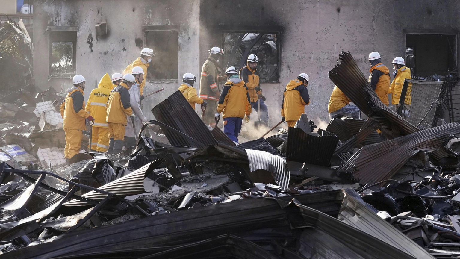 Firefighters remove the debris from a fire at a burnt market in Wajima, Ishikawa prefecture, Japan Saturday, Jan. 6, 2024. A series of powerful quakes set off a large fire in the town of Wajima, as we ...