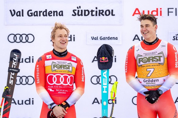 epa12604957 Second placed Marco Odermatt (L) of Switzerland and winner Franjo von Allmen (R) of Switzerland celebrate on the podium after the Men's Downhill race at the FIS Alpine Skiing World Cu ...