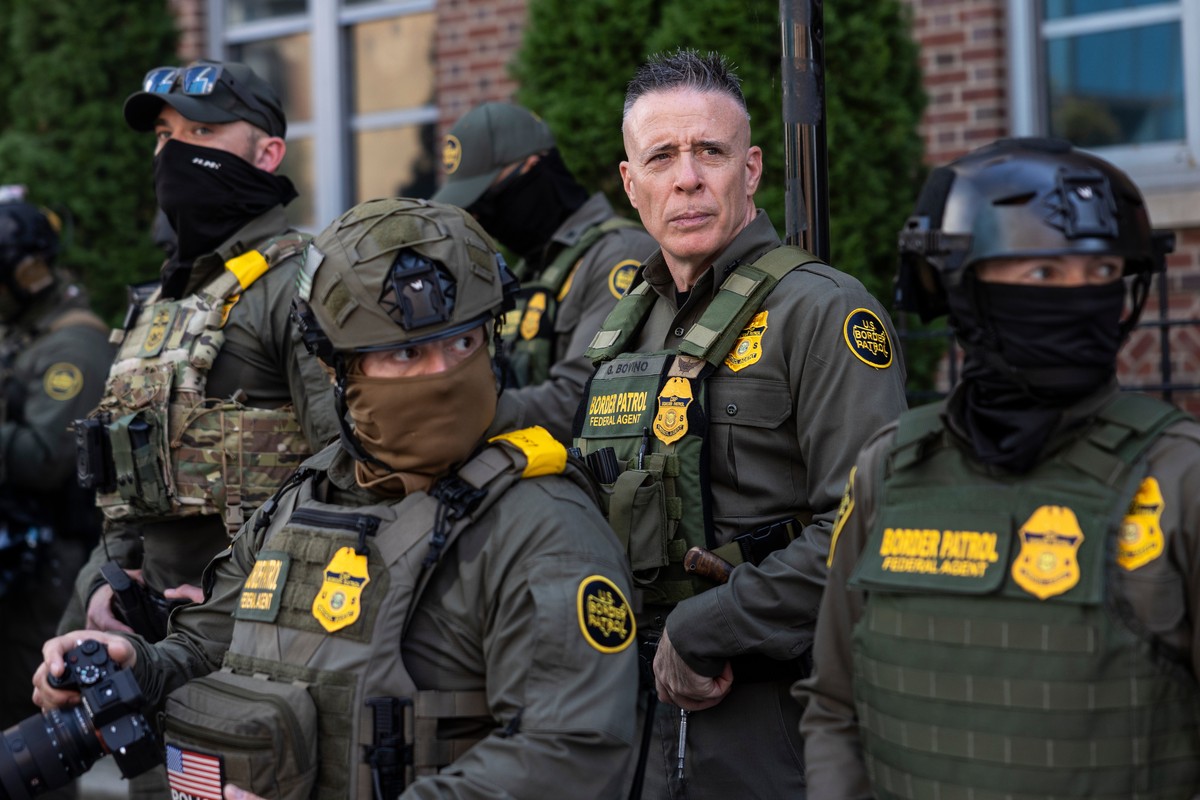 Greg Bovino, the chief patrol agent for the U.S. Border Patrol El Centro sector, stands with federal immigration agents as they keep watch while detaining a man who took off running away from them as  ...