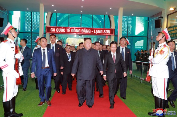 In this Tuesday, Feb. 26, 2019, photo provided by the North Korean government, North Korean leader Kim Jong Un, center, arrives at the Dong Dang railway station in Dong Dang, Vietnam, ahead of his sec ...