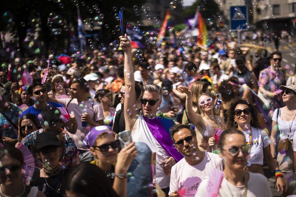 People take part in the Zurich Pride parade in Zurich, Switzerland, on Saturday, June 17, 2023. (KEYSTONE/Michael Buholzer)