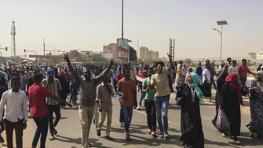 Sudanese celebrate after officials said the military had forced longtime autocratic President Omar al-Bashir to step down after 30 years in power in Khartoum, Sudan, Thursday, April 11, 2019. (AP Phot ...