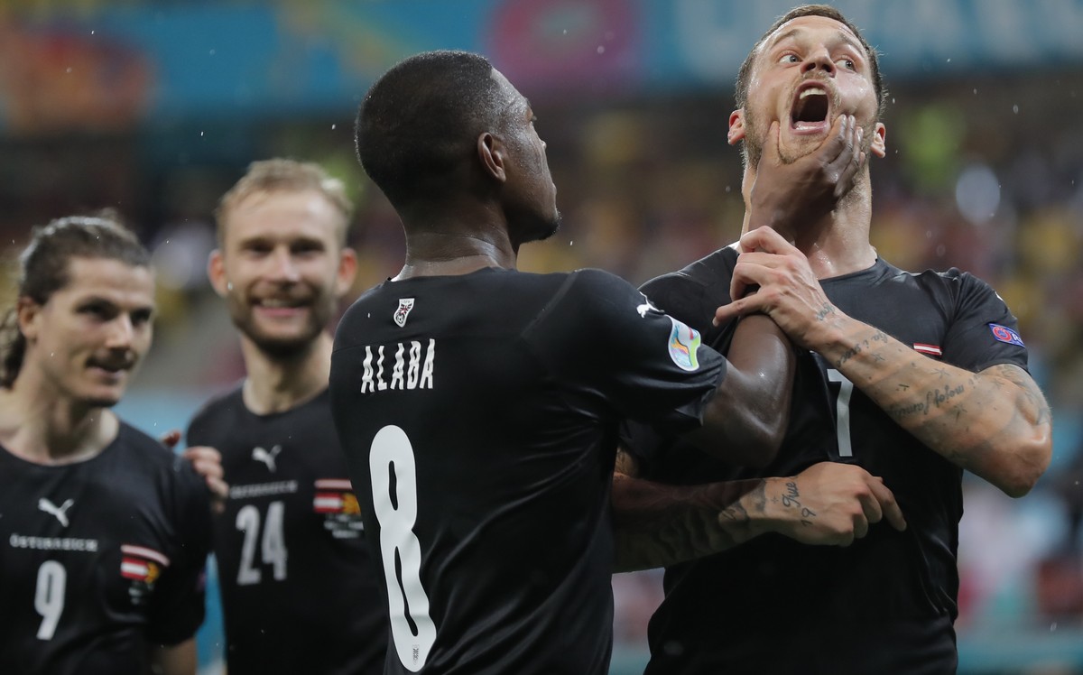 Austria's Marko Arnautovic, right, celebrates with Austria's David Alaba after scoring his side's third goal during the Euro 2020 soccer championship group C match between Austria and N ...