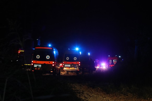 epa10075434 Ambulances are seen at the area where an Ukraine Antonov cargo aircraft has crashed in the Paleiochori area, west of Kavala, north Greece, 17 July 2022. An Antonov An-12 was flying from Se ...