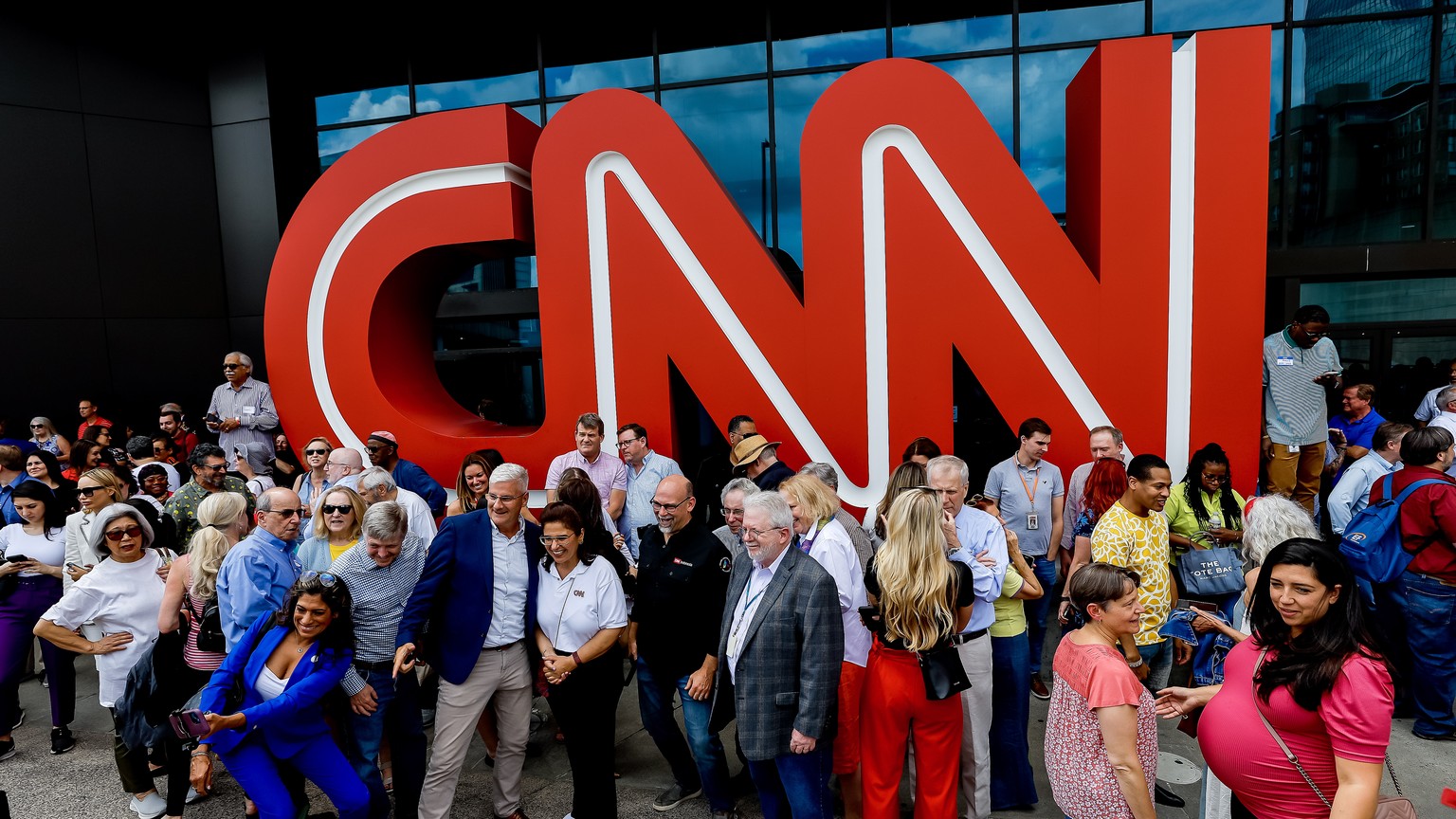 epa10667746 Hundreds of current and former CNN (Cable News Network) employees pose for a group photo outside the CNN Center on the 43rd anniversary of the network in Atlanta, Georgia, USA, 01 June 202 ...