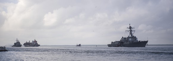 epa07011369 A handout photo made available by the Navy Office of Information shows The guided-missile destroyer USS Nitze (DDG 94), front, and the guided-missile cruiser USS Leyte Gulf (CG 55) depart  ...