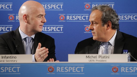 UEFA President Michel Platini, right, speaks with UEFA General Secretary Gianni Infantino , during a press conference, one day prior to the Euro 2016 qualifying draw, at the Acropolis Convention Centr ...