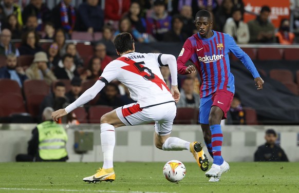 epa09907496 Barcelona's Ousmane Dembele (R) duels for the ball against Rayo's defender Alejandro Catena (L) during the Spanish LaLiga soccer match between FC Barcelona and Rayo Vallecano at Camp Nou stadium in Barcelona, Catalonia, Spain, 24 April 2022.  EPA/Toni Albir