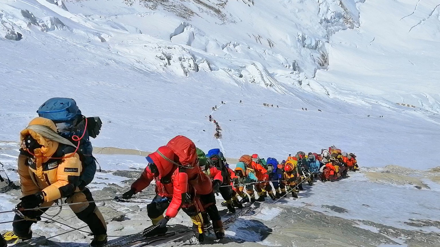 FILE - In this May 22, 2019, file photo, a long queue of mountain climbers line a path on Mount Everest just below camp four, in Nepal. Expedition operators on Mount Everest say that Chinese mountaine ...