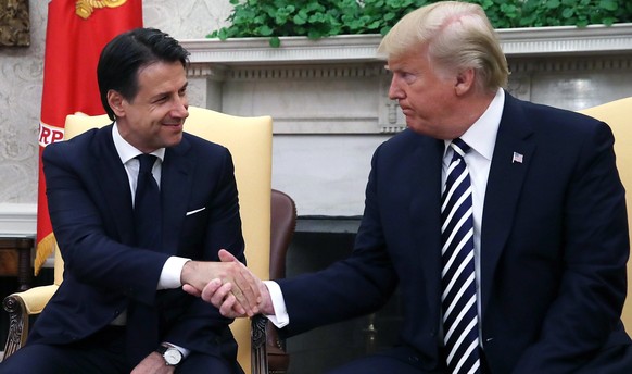 epa06919296 US President Donald J. Trump (R) shakes hands with Italian Prime Minister Giuseppe Conte (L) in the Oval Office of the White House, in Washington, DC, USA, 30 July 2018. EPA/Mark Wilson /  ...