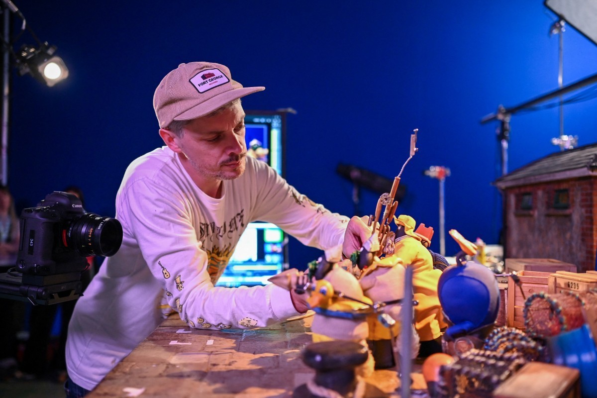 This photo taken on March 4, 2026 shows Ed Jackson, an animator for 'Shaun the Sheep: The Beast of Mossy Bottom', working on a set at Aardman Animations studios in Bristol, western England.  ...